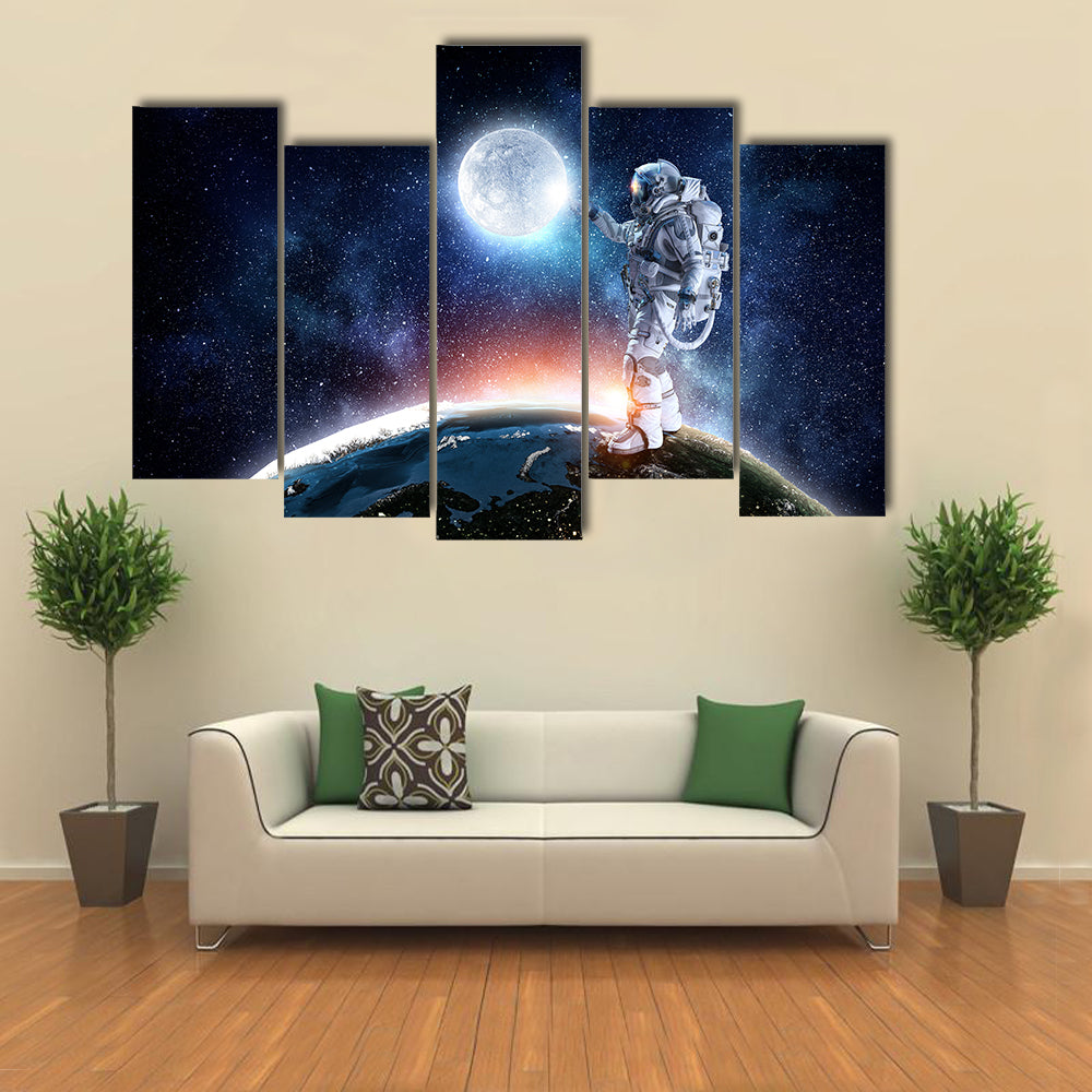 Astronaut Pointing The Moon For A Candid Click Multi Panel Canvas Wall Art