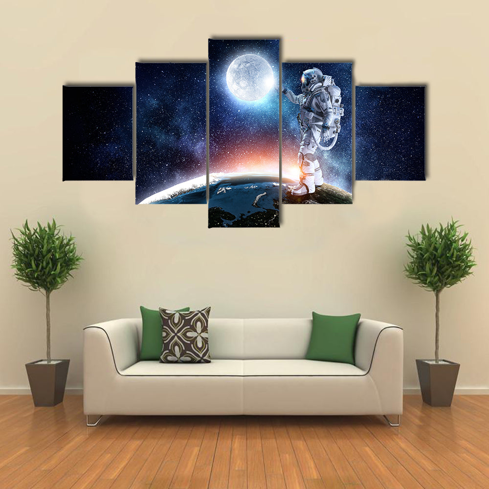 Astronaut Pointing The Moon For A Candid Click Multi Panel Canvas Wall Art