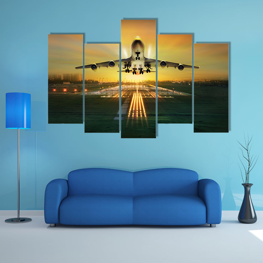 A Lit View Of Passenger Plane During Takeoff From Runway Multi Panel Canvas Wall Art