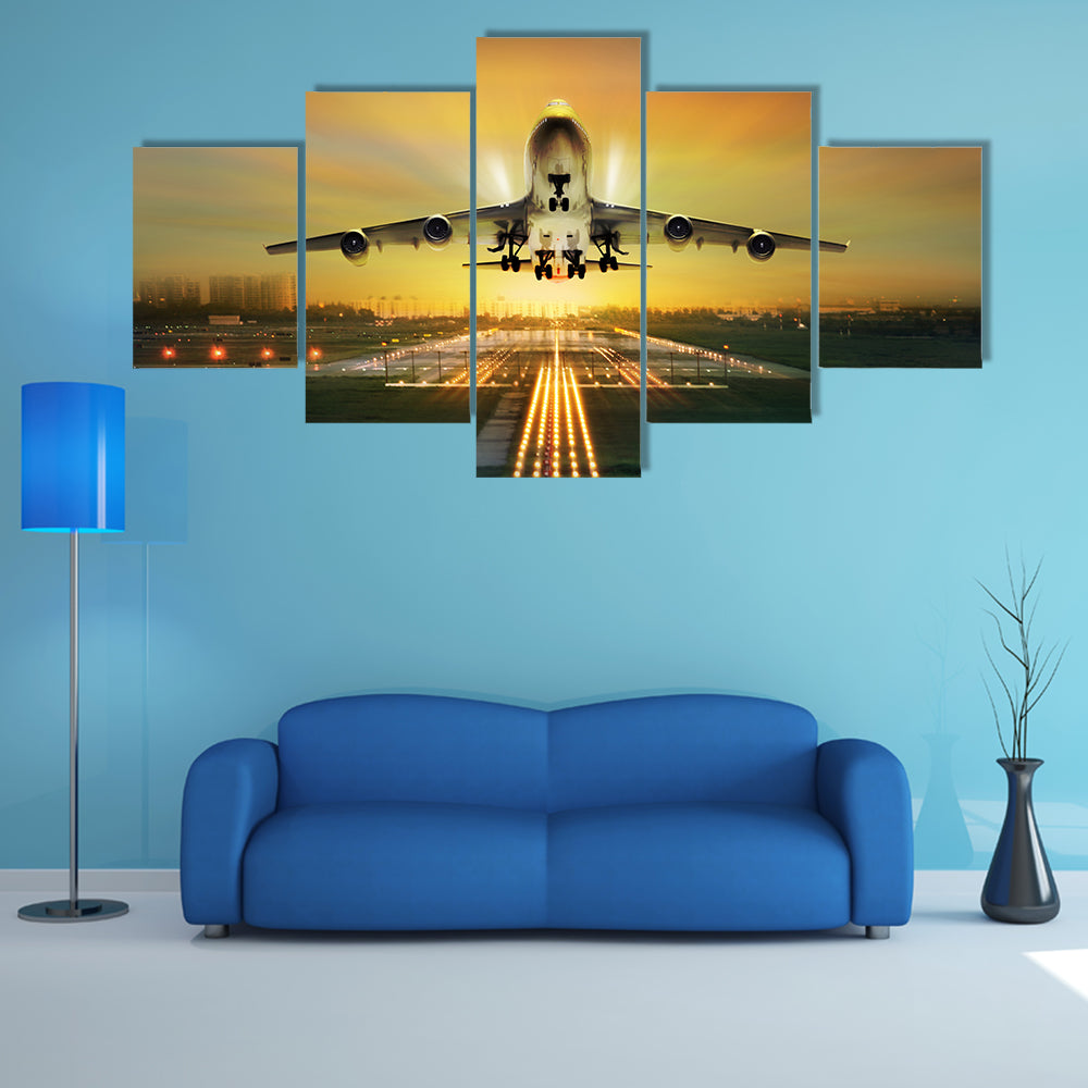 A Lit View Of Passenger Plane During Takeoff From Runway Multi Panel Canvas Wall Art
